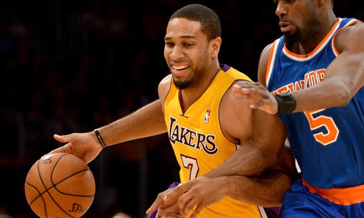 Lakers guard Xavier Henry, left, drives past New York Knicks guard Tim Hardaway Jr. during a game in March. Henry has been limited to 43 games this season because of injuries.