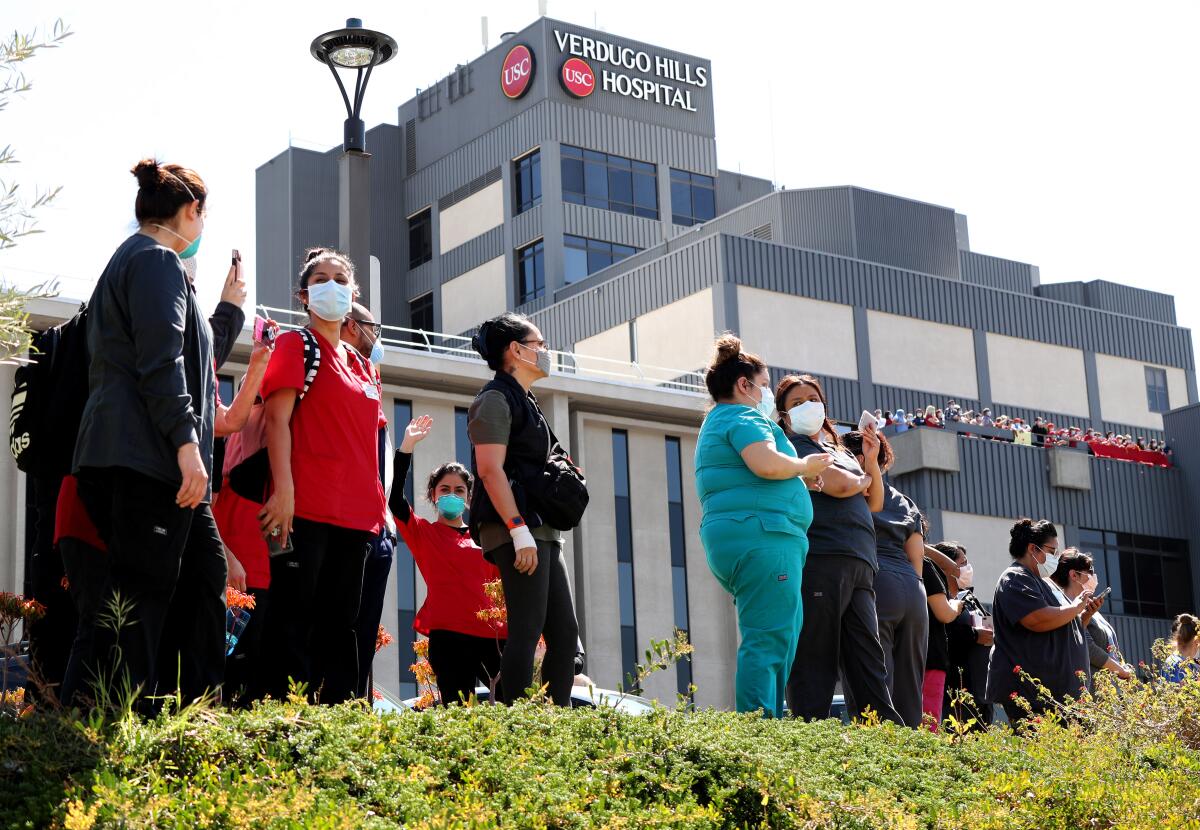 Healthcare workers thank police and fire personnel who came to show their appreciation for USC Verdugo Hills Hospital employees, Wednesday, April 15, 2020.