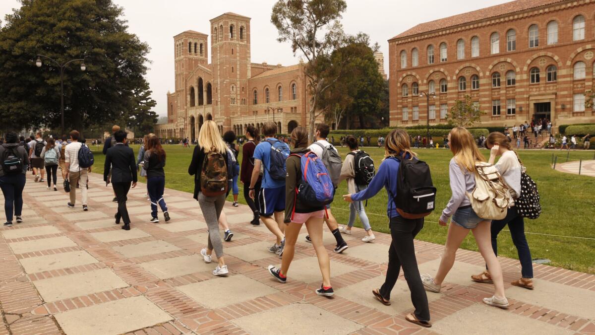 Students return to campus Wednesday after a shooting at UCLA.