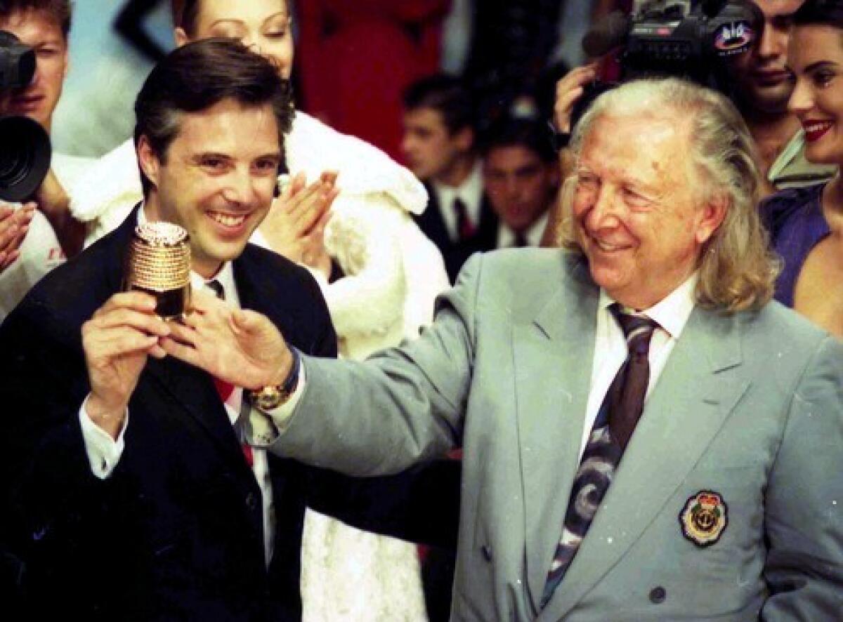 French designer Ted Lapidus, right, seen with his son, Olivier, in Paris in 1994, helped redefine chic. French President Nicolas Sarkozy said Lapidus made fashion accessible to men and women in the street.