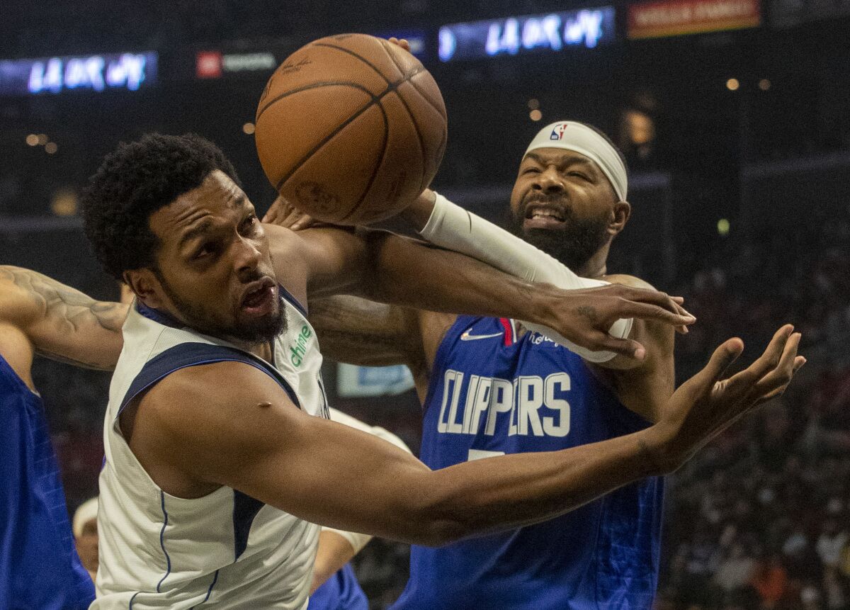 Clippers forward Marcus Morris Sr. battles Dallas Mavericks forward Sterling Brown for a rebound.