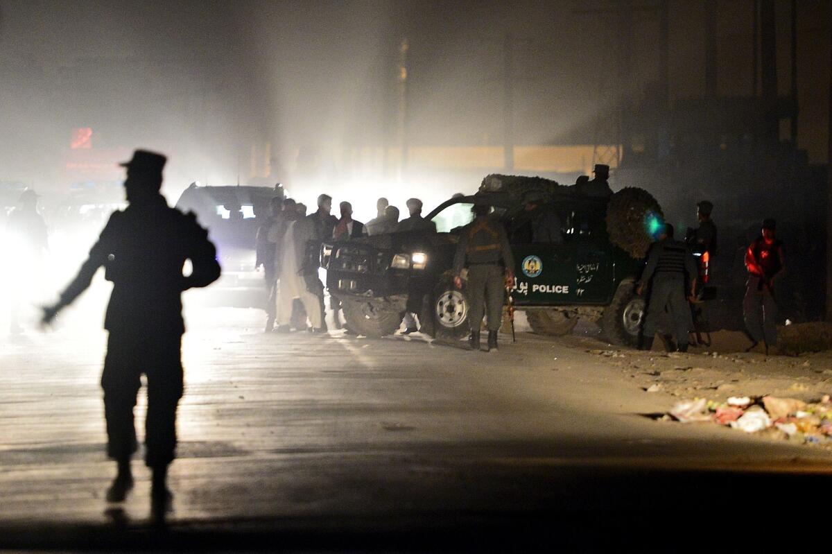 Afghan police gather at the site of an attack near a compound for foreign residents in Kabul on Friday.