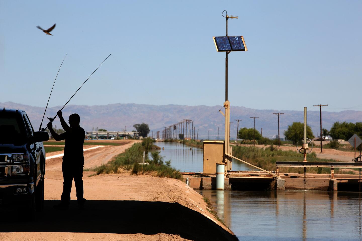 Randall McDaniel, 22, prepares to fish in Westside Main Canal, which brings irrigation water from the Colorado River into the Imperial Valley for farming. Modern irrigation -- aided by the Hoover Dam and the All-American Canal -- transformed the Imperial Valley from a hostile desert into an agricultural marvel.