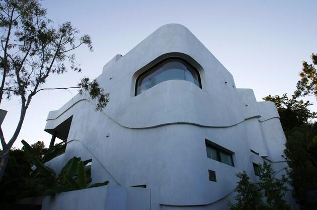 The white stucco facade of Jill Greenberg's house is a subtle nod to a relief map. "This site is actually a drainage zone, so I studied old geological maps and superimposed topography lines on the building's surfaces," designer Beth Holden said. "I tried to create moments between the existing site and the new architecture."