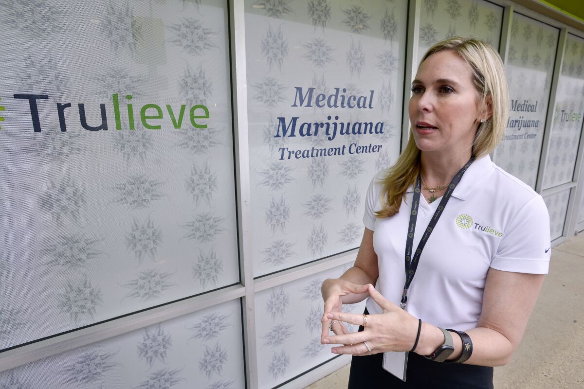 FILE - In this Friday, Jan. 10, 2020 file photo, Trulieve Cannabis Corp. Chief Executive Officer Kim Rivers talks about the company's newest medical marijuana dispensary location, which opened in Fort Walton Beach, Fla. Trulieve CEO Kim Rivers recently spoke to The Associated Press about the impact of the Harvest deal, how her company has weathered the pandemic and the need for federal legislation to free up banks to do business with licensed marijuana companies.(Devon Ravine/Northwest Florida Daily News via AP, File)