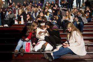 NEW YORK, NY - DECEMBER 01: A group of teens look at a photograph they took on a smartphone in Times Square, December 1, 2017 in New York City. The photo-sharing app Instagram has released data for its most-Instagrammed cities and locations for 2017. New York City is ranked number one, with Moscow and London coming in second and third. Among the most photographed locations in New York City were the Brooklyn Bridge, Times Square and Central Park. (Photo by Drew Angerer/Getty Images)