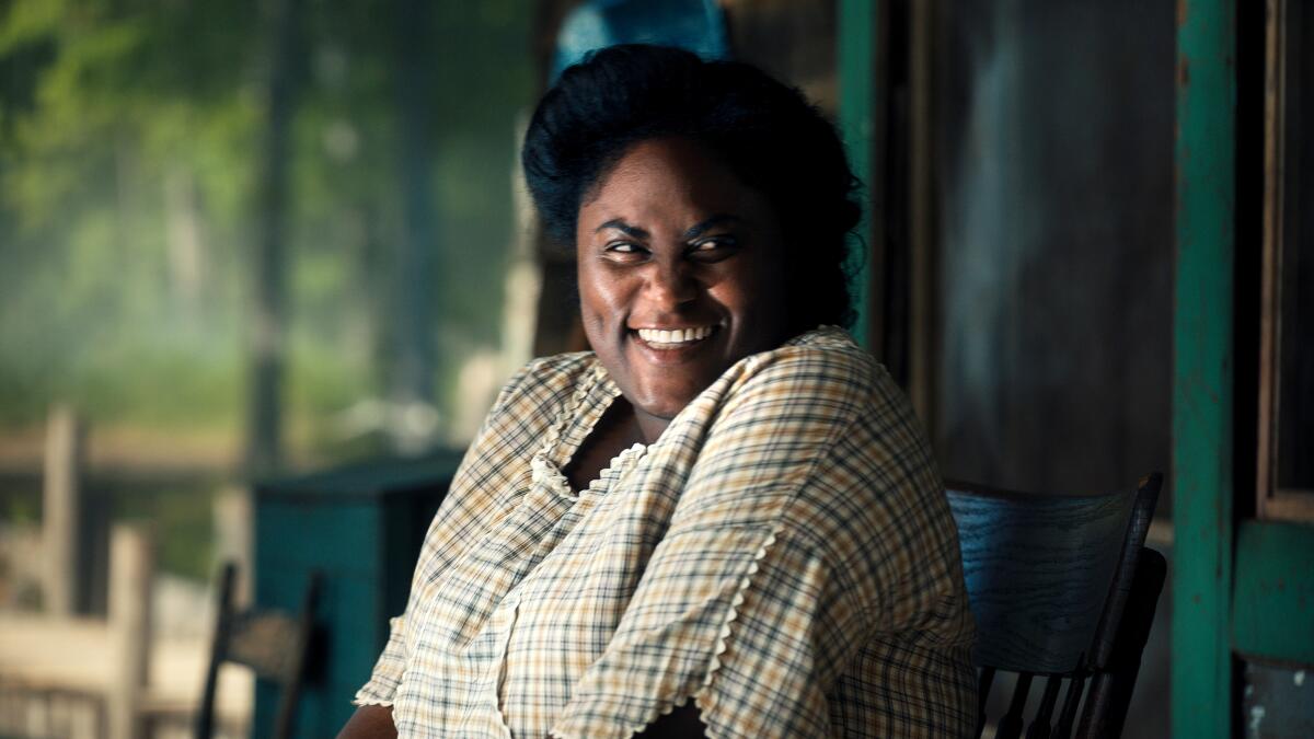 A woman smiles happily in "The Color Purple."