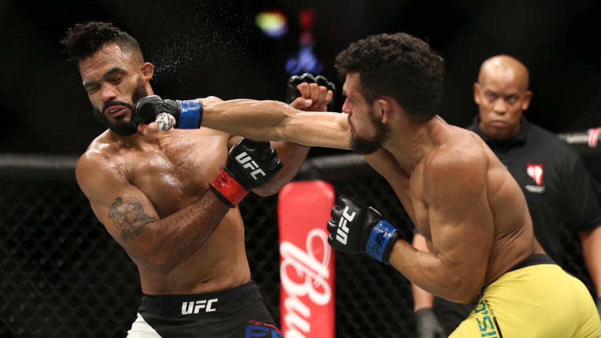 Douglas Silva de Andrade lands a punch against Rob Font during their fight at UFC 213.