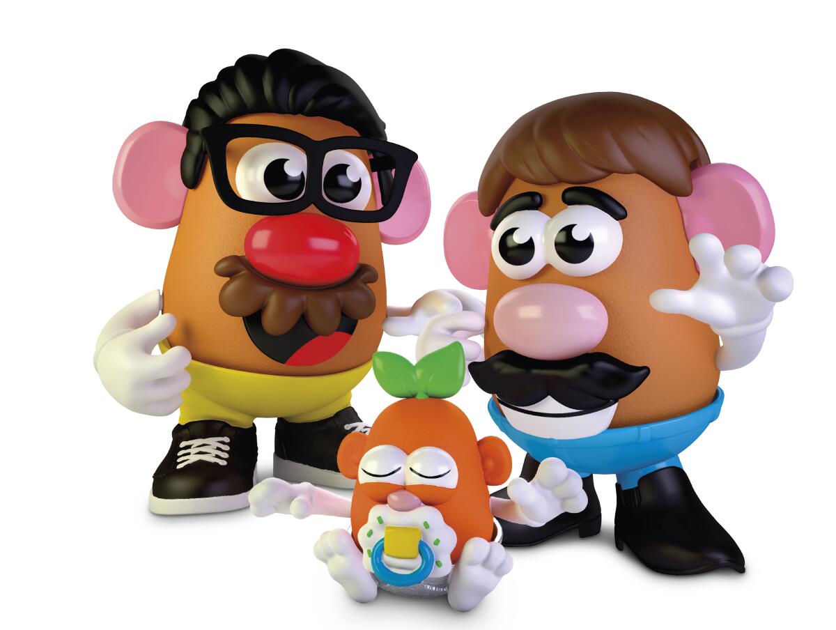 Two adult Potato Head toys with a little Potato Head baby