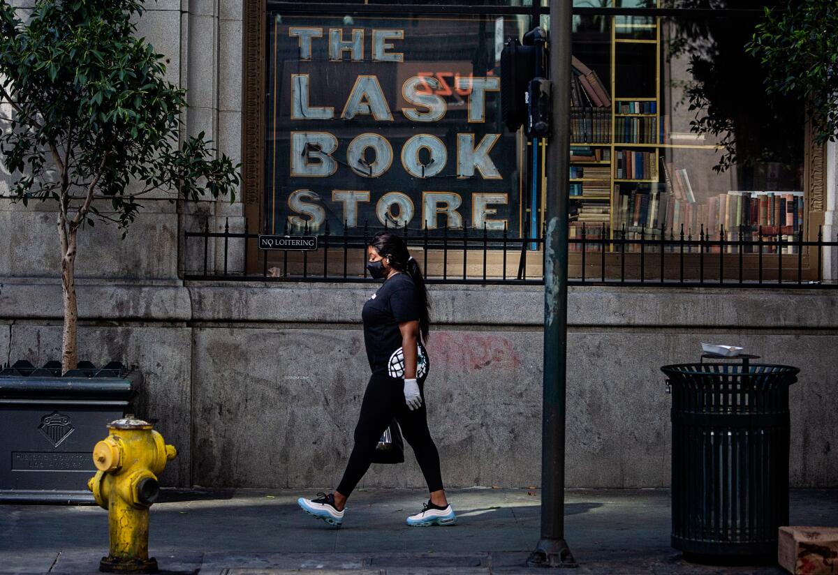 A woman walks by the Last Bookstore in downtown Los Angeles.