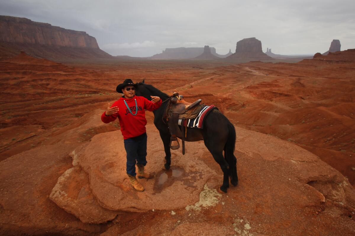 Navajo Adrian Jackson with his trusty horse, Pistol, awaits the next group of tourists eager to snap pictures at John Ford's Point.