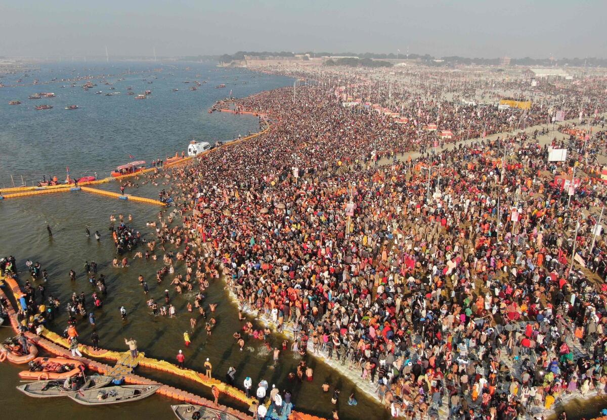 Hindu devotees taking a holy dip at Sangam — the confluence of the Ganges, Yamuna and mythical Saraswati rivers — during the auspicious bathing day of Makar Sankranti at the Kumbh Mela in the town formerly known as Allahabad.