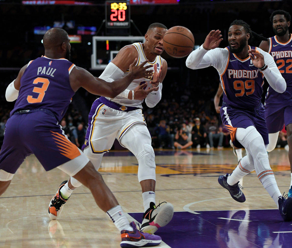 Lakers star Russell Westbrook, center, loses control of the ball against Phoenix's Chris Paul.