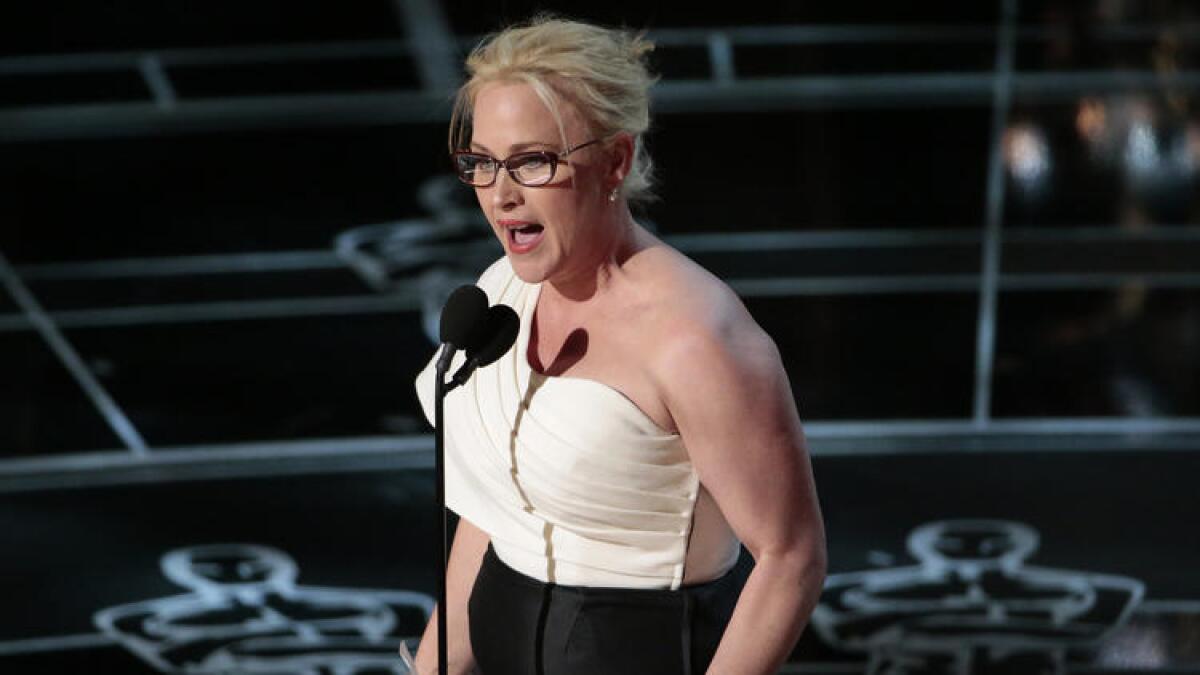 Patricia Arquette accepts the supporting actress Oscar for her role in "Boyhood" at the 87th Academy Awards.