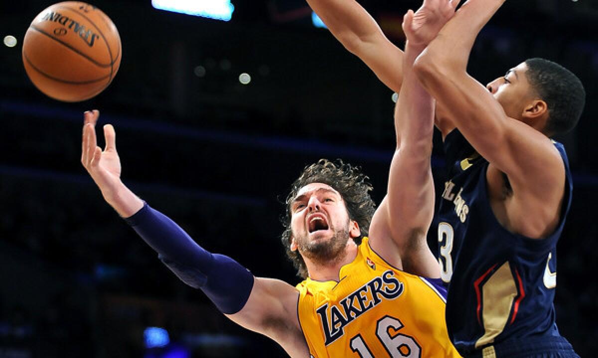 Lakers center Pau Gasol, left, puts up a shot in front of New Orleans Pelicans forward Anthony Davis during the Lakers' Nov. 10 loss.