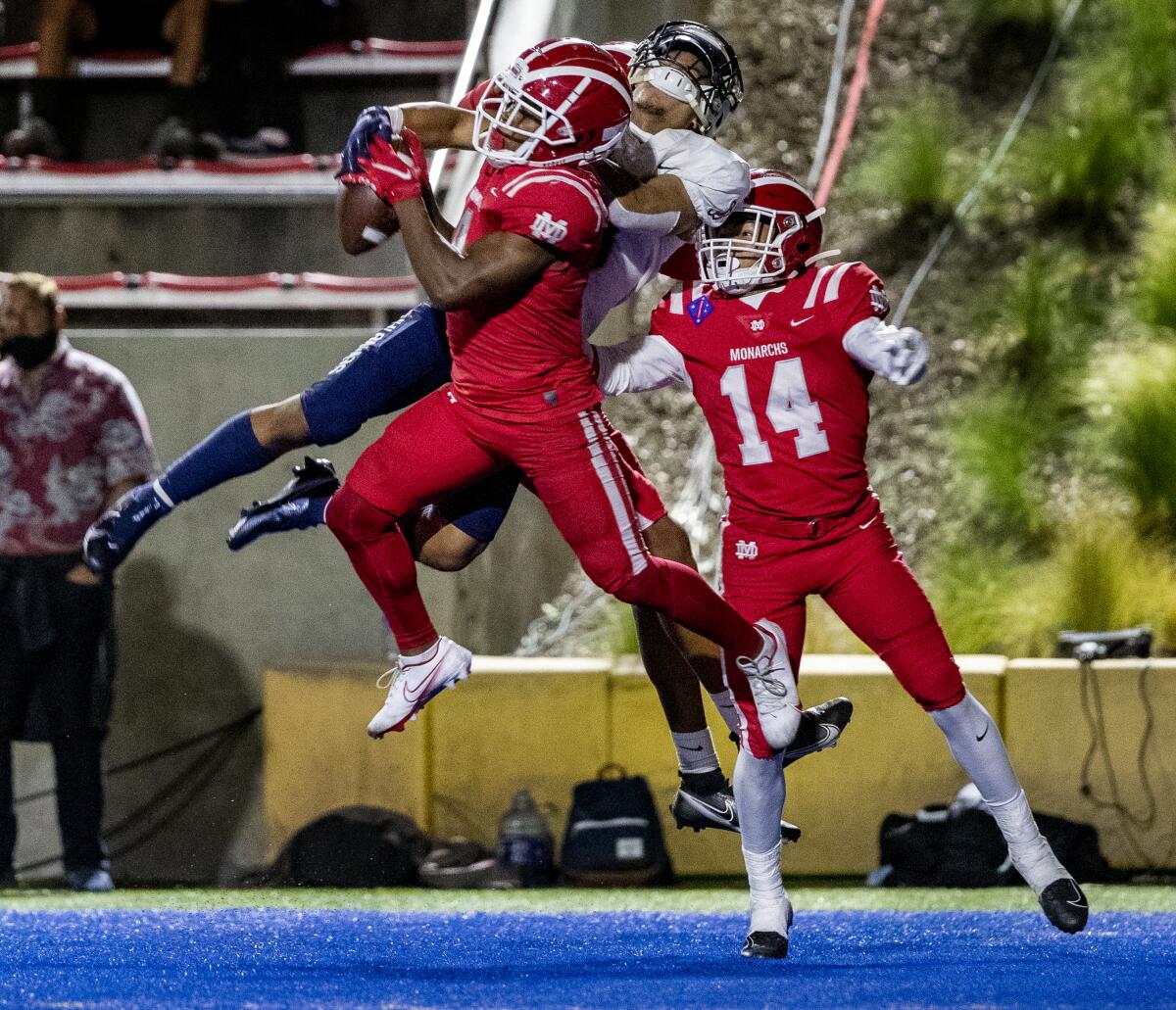 Mater Dei's Shu'yab Brinkley intercepts a pass in the end zone intended for St John Bosco's James Chedon.