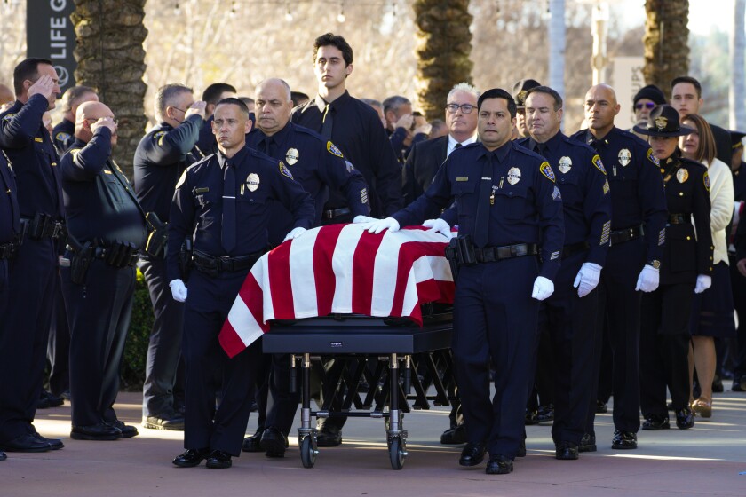 Pallbearers escort the casket of San Diego Police Officer Gary Bowen into the North Coast Church.2.