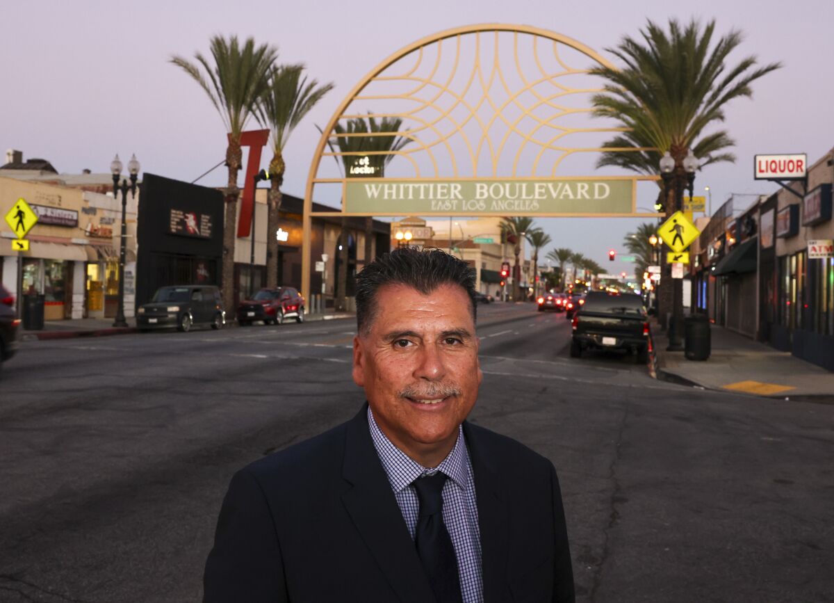 L.A. County Sheriff candidate Robert Luna near a sign welcoming visitors to Whittier Boulevard in East Los Angeles