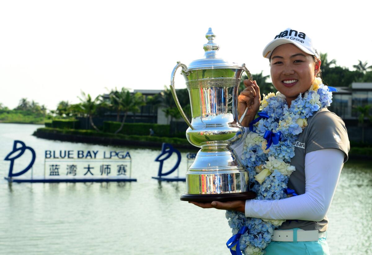 Minjee Lee poses with her trophy after winning the Blue Bay LPGA tournament at Jian Lake Blue Bay Golf Course in Sanya on China's Hainan Island on Oct. 23.