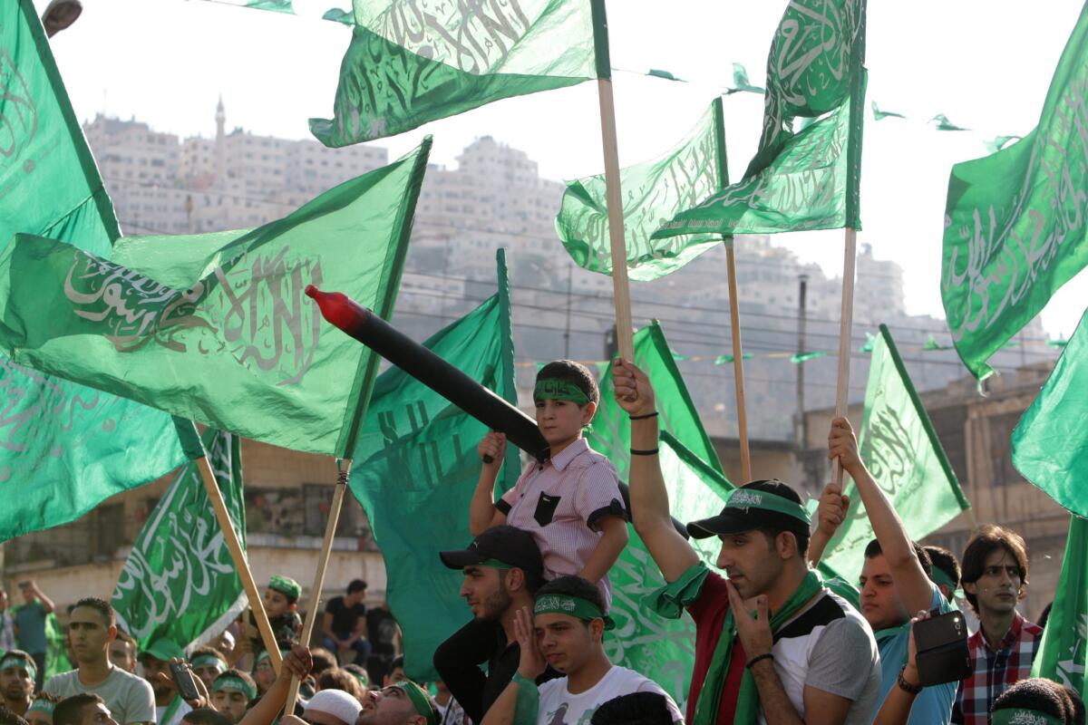 Palestinians hold Hamas flags during a celebration organized by Hamas in the West Bank city of Nablus on Aug. 29.