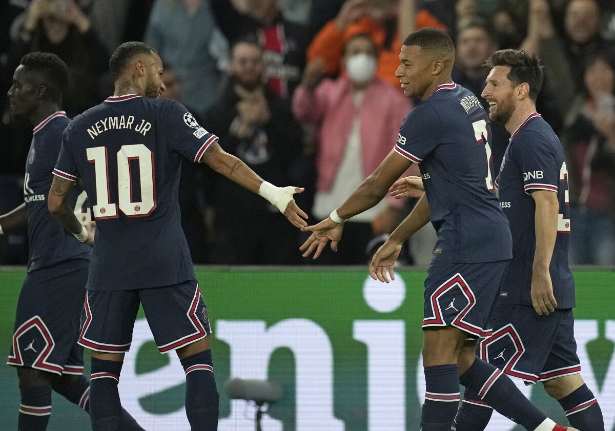 PSG's Lionel Messi, right, celebrates with Neymar and Kylian Mbappe after scoring his side's second goal during the Champions League Group A soccer match between Paris Saint-Germain and Manchester City at the Parc des Princes in Paris, Tuesday, Sept. 28, 2021. (AP Photo/Christophe Ena)