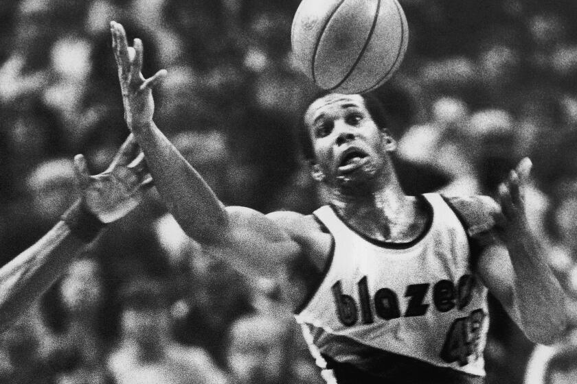 FILE - In this Dec. 25, 1979, file photo, Portland Trail Blazers' Kermit Washington gains control of a loose ball during an NBA basketball game against the Golden State Warriors in Portland, Ore. Washington has pleaded guilty Thursday, Nov. 30, 2017, to spending thousands of dollars donated to an African charity he organized on jewelry, vacations and other personal items. Washington was scheduled to go to trial in federal court Monday, Dec. 4, 2017, in Kansas City, Mo., but instead pleaded guilty Thursday. (AP Photo/Jack Smith, File)
