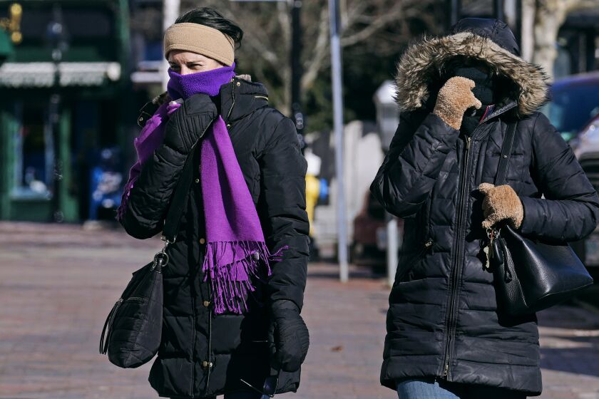 Two women are bundled up in cold weather clothing while walking during a frigid weather snap, Friday, Feb. 3, 2023, in Portsmouth, N.H. Windchills in New England are expected to be sub-zero on Friday and Saturday across the region. (AP Photo/Charles Krupa)
