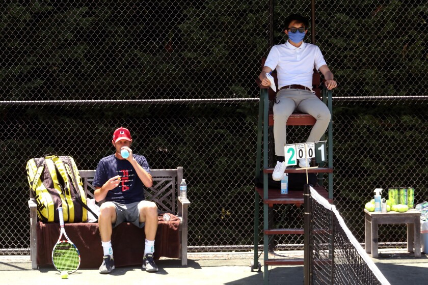Sam Querrey, left, and umpire Albert Ton, masked.