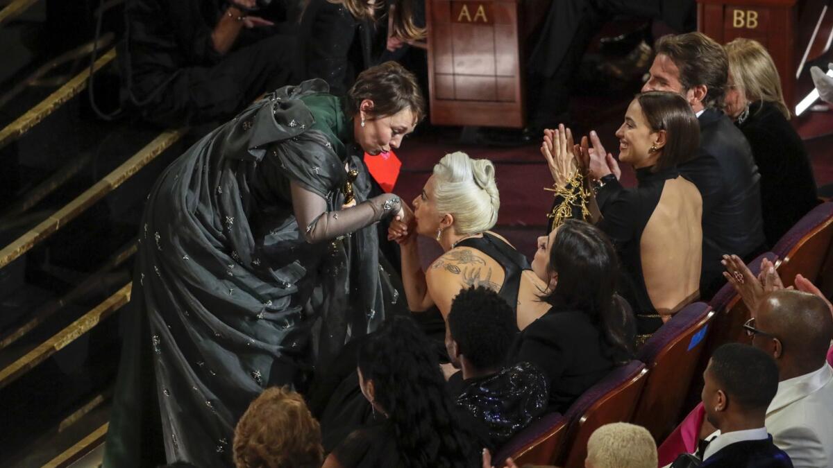 Olivia Colman connects with Lady Gaga after she accepted the award for best actress for "The Favourite" during the Academy Awards on Sunday.
