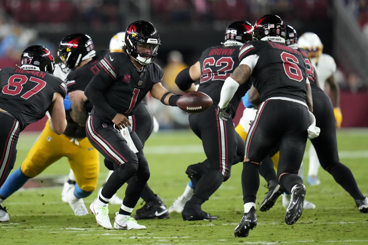 Arizona Cardinals quarterback Kyler Murray hands the ball off to running back James Conner during the first half.