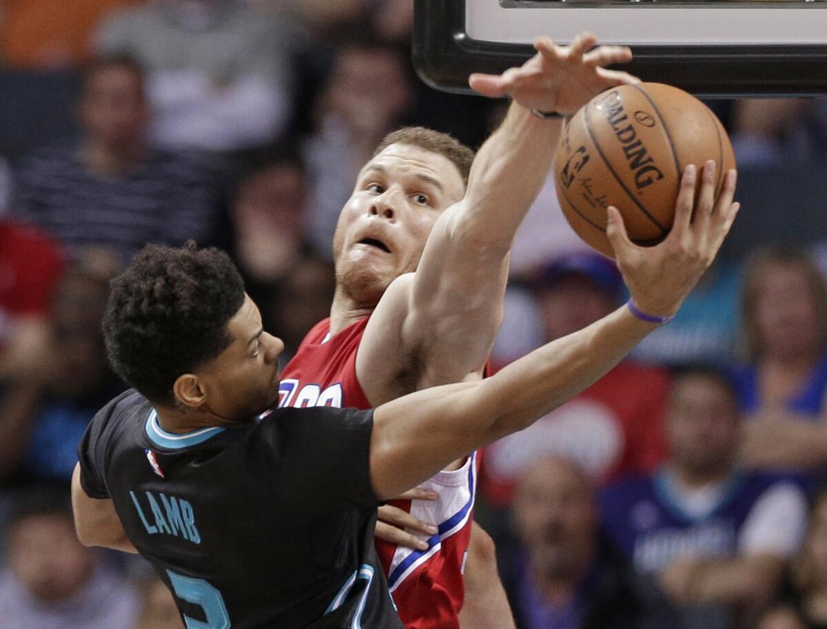 Clippers forward Blake Griffin blocks a shot by Hornets guard Jeremy Lamb during the second half of a game on Feb. 11.