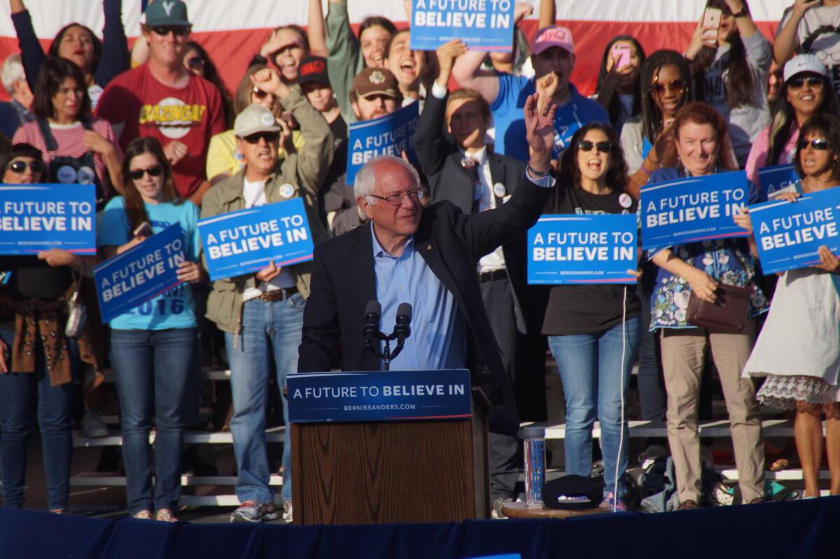 Sen. Bernie Sanders (D-Vt.) greets supporters at a rally for his presidential campaign Sunday at the Irvine Meadows Amphitheatre. He called his campaign a fight for a “radical” departure from American politics as usual.
