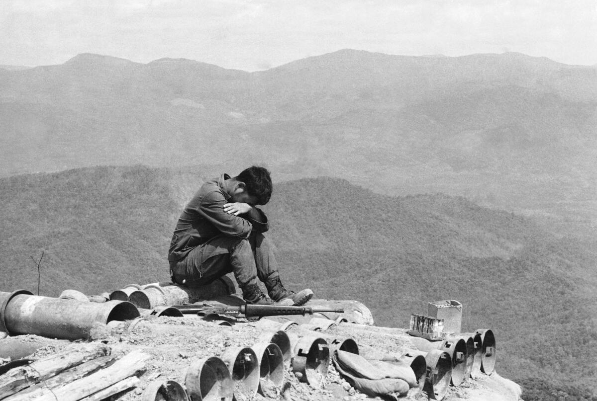 A South Vietnamese soldier rests his eyes at a lonely outpost northeast of Kontum, 270 miles north of Saigon, March 25, 1974. The hill overlooks a vital North Vietnamese supply road and is located rear the scene of some of the bloodiest fighting in South Vietnam since the cease fire. The soldiers on the hill say the enemy is "all around them." (AP Photo/Nick Ut)
