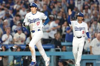 The Dodgers' Shohei Ohtani rounds the bases after hitting a two-run home run against the Rangers 