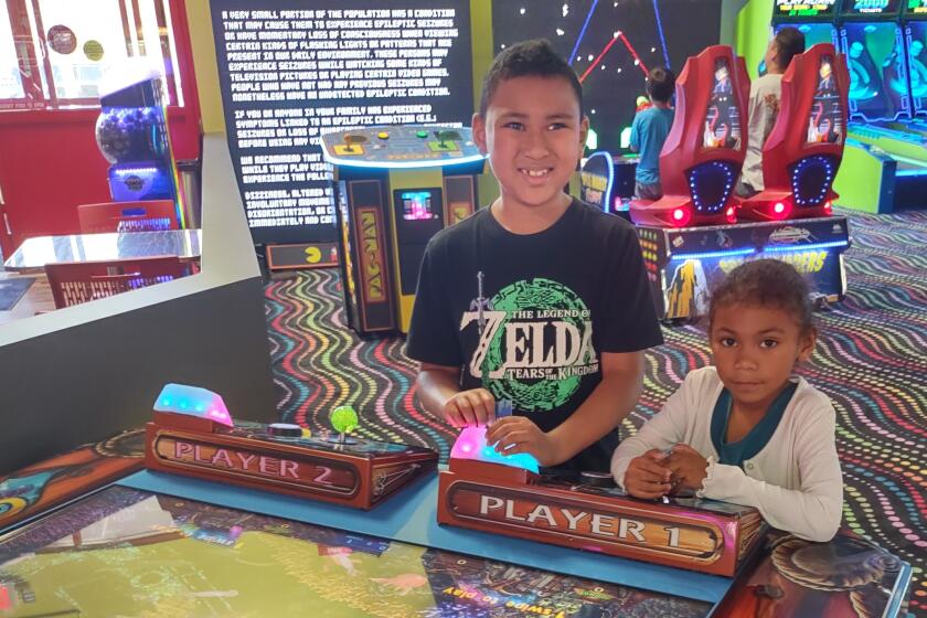 A.J. Robinson, left, and his sister, Aria Robinson, had fun playing games at City Fun Center for the first time on Friday.