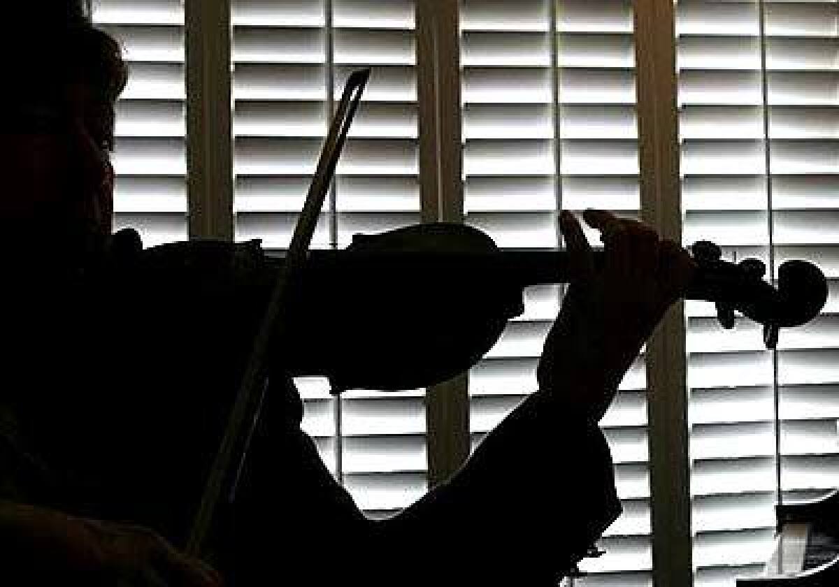 Violinist Diana Steiner rehearses in the living room of her Spanish Revival in Brentwood.