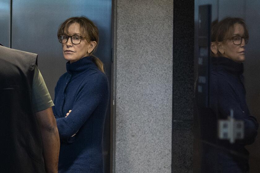 Actress Felicity Huffman is seen inside the Edward R. Roybal Federal Building and U.S. Courthouse in Los Angeles, on March 12, 2019. - Two Hollywood actresses including Oscar-nominated "Desperate Housewives" star Felicity Huffman are among 50 people indicted in a nationwide university admissions scam, court records unsealed in Boston on March 12, 2019 showed. The accused, who also include chief executives, allegedly cheated to get their children into elite schools, including Yale, Stanford, Georgetown and the University of Southern California, federal prosecutors said.Huffman, 56, and Lori Loughlin, 54, who starred in "Full House," are charged with conspiracy to commit mail fraud and honest services mail fraud. A federal judge set bond at $250,000 for Felicity Huffman after she was charged in a massive college admissions cheating scandal. (Photo by DAVID MCNEW / AFP)DAVID MCNEW/AFP/Getty Images ** OUTS - ELSENT, FPG, CM - OUTS * NM, PH, VA if sourced by CT, LA or MoD **
