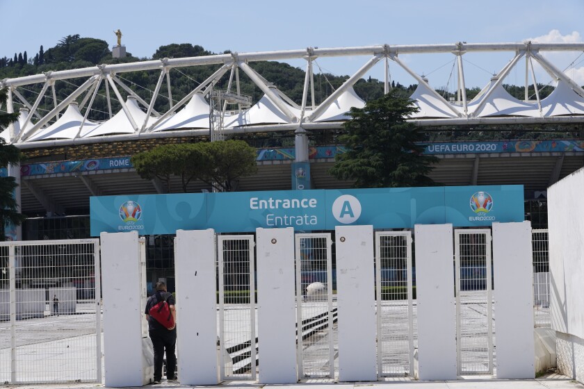 A man enters Rome's Olympic stadium, Wednesday, June 9, 2021. The Euro 2020 gets underway on Friday June 11 and is being played in 11 host cities across 11 countries. (AP Photo/Alessandra Tarantino)