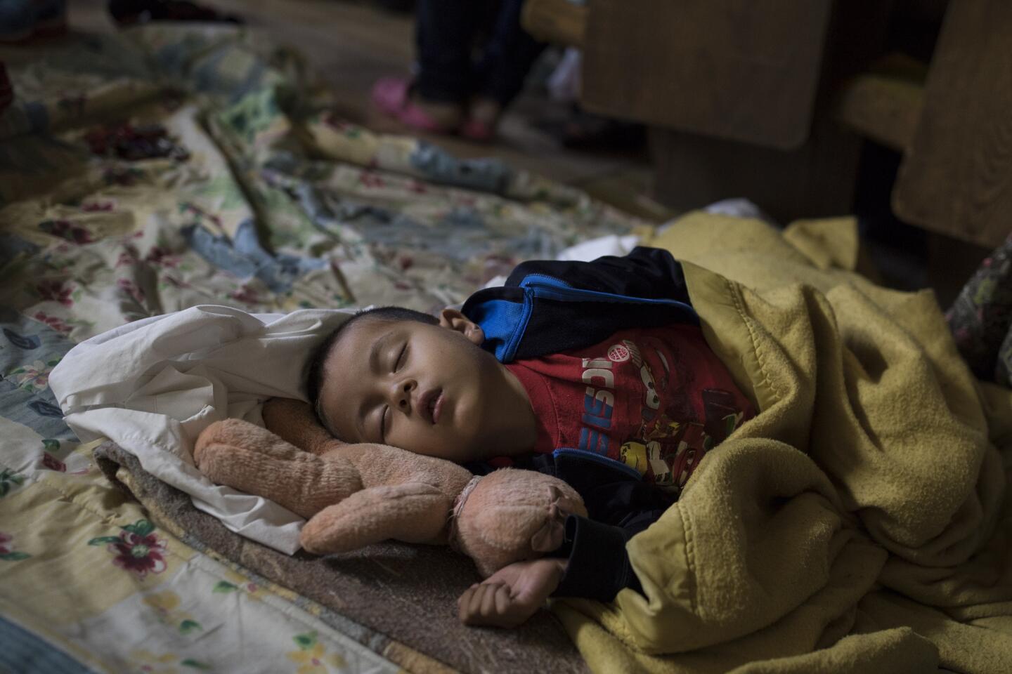 A Central American child who is traveling with a caravan of migrants sleeps at a shelter in Tijuana, Mexico, on April 29, 2018. U.S. immigration lawyers are telling Central Americans in a caravan of asylum-seekers that traveled through Mexico to the border with San Diego that they face possible separation from their children and detention for many months.