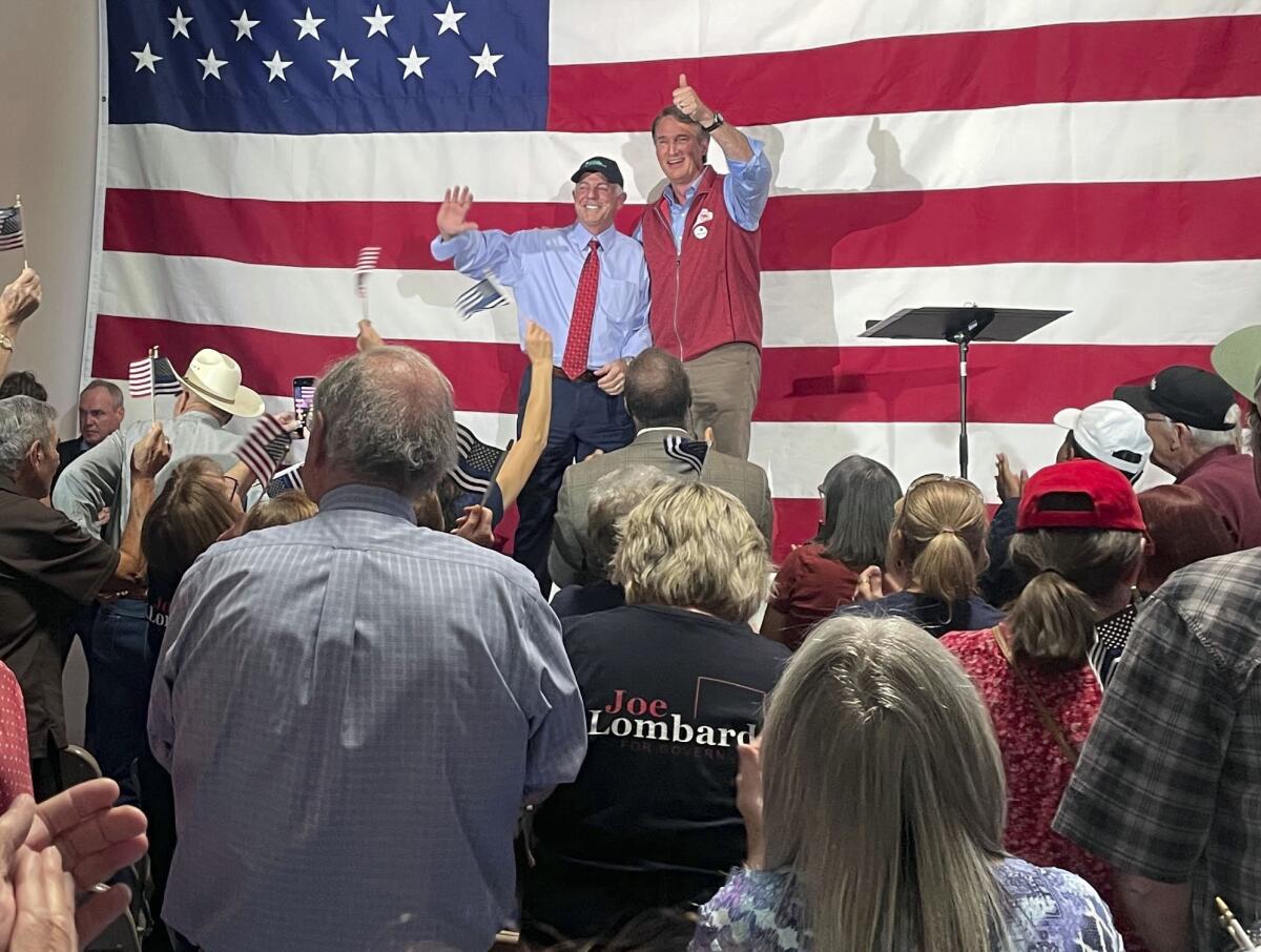 Virginia Gov. Glenn Youngkin, center right, gives a thumbs-up at an event in support of Nevada Republican gubernatorial nominee Joe Lombardo, center left, at the Nevada Trucking Association in Reno, Nev., Thursday, Sept. 15, 2022. (AP Photo/Gabe Stern)