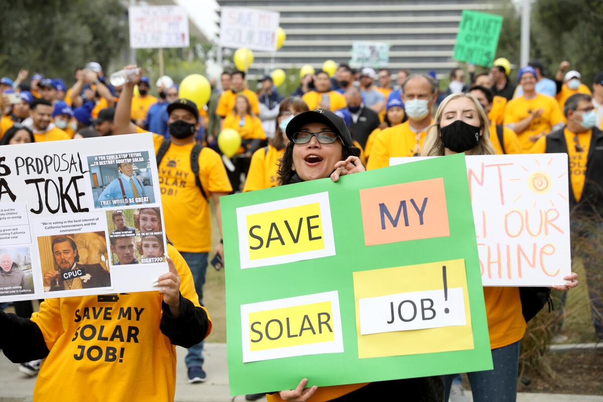 Solar workers rally at L.A.'s Grand Park in January, urging state officials not to slash rooftop solar incentives.