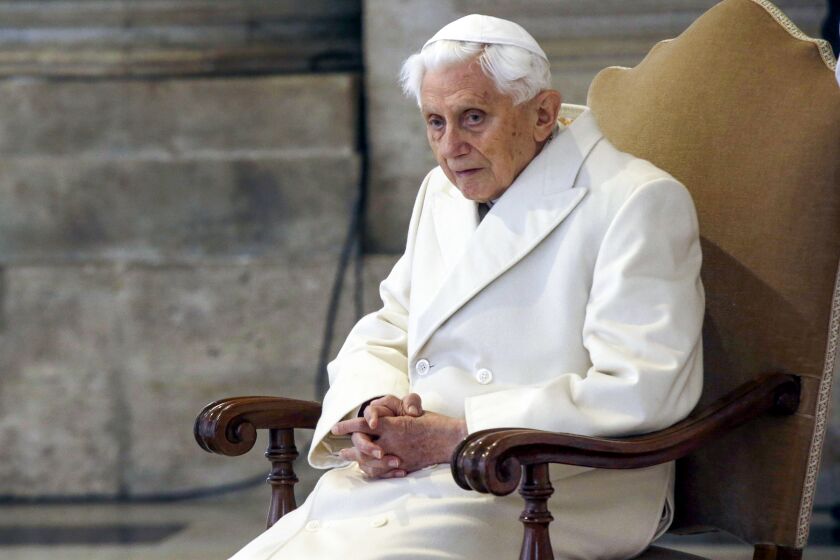 Pope Emeritus Benedict XVI sitting in St. Peter's Basilica
