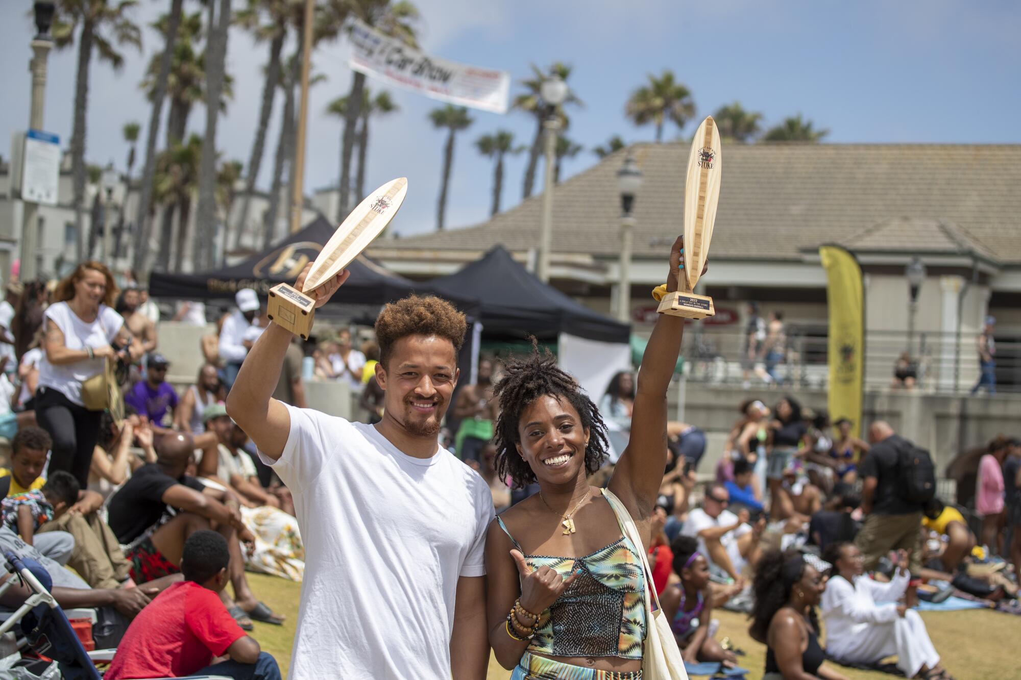 Brandon Benjamin of Santa Barbara, left, and Divinity Gaines of L.A. hold up trophies they won.