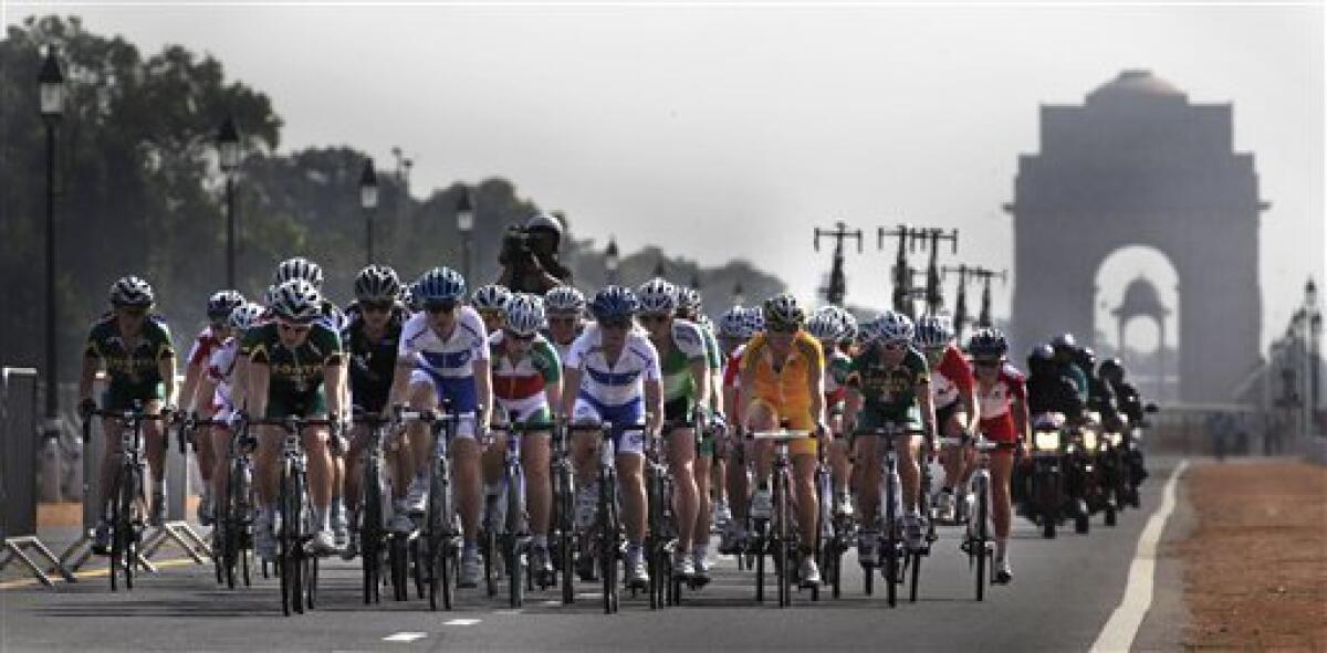Participants ride past the India Gate monument in the women's 112km cycling road race during the Commonwealth Games in New Delhi, India, Sunday, Oct. 10, 2010. (AP Photo/Manish Swarup)