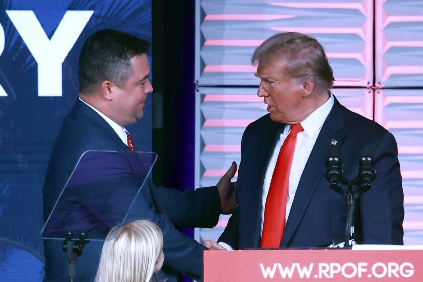 Republican Party of Florida chairman Christian Ziegler, left, greets former president Donald Trump at the RPOF Freedom Summit on Nov. 4, 2023, in Kissimmee, Fla. Ziegler is the subject of a rape investigation, though no charges have been filed and police are providing little information on the accusation. (Joe Burbank/Orlando Sentinel via AP)