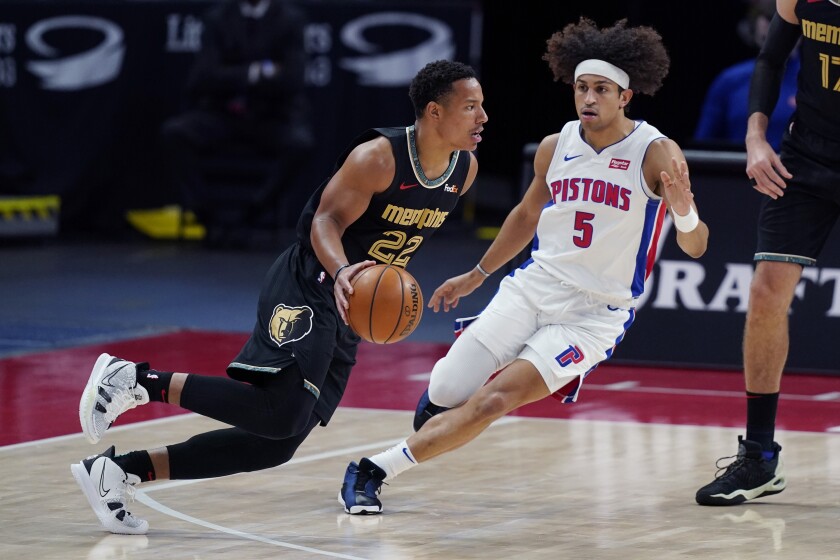 Memphis Grizzlies guard Desmond Bane (22) drives as Detroit Pistons guard Frank Jackson (5) defends during the first half of an NBA basketball game, Thursday, May 6, 2021, in Detroit. (AP Photo/Carlos Osorio)