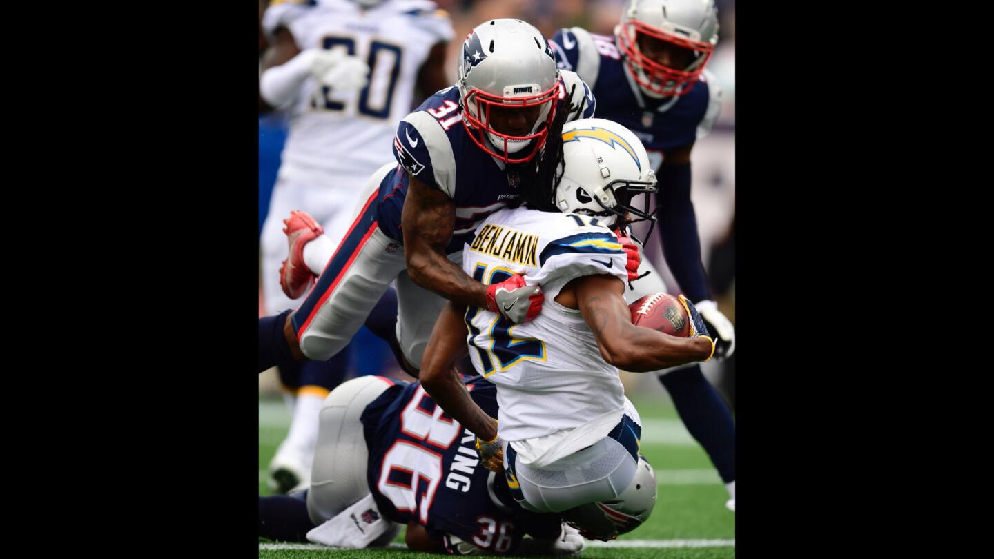 New England Patriots defensive back Brandon King (L) and New England Patriots cornerback Jonathan Jones (C) tackle Los Angeles Chargers wide receiver Travis Benjamin (R) in the end zone for a safety.