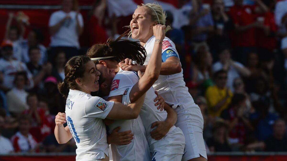 England's (from left) Karen Carney, Lucy Bronze, Fara Williams and Steph Houghton celebrate a goal during a 2-1 victory over Norway in the women's World Cup knockout round on Monday.