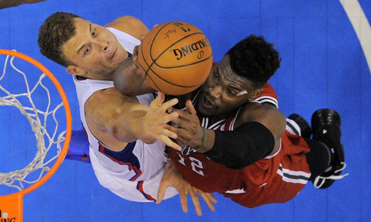 Clippers power forward Blake Griffin, left, tries to block a shot by Milwaukee Bucks forward Jeff Adrien during the Clippers' win Monday.