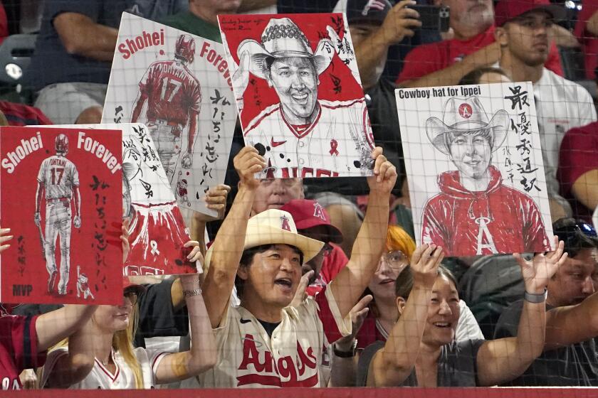 Los Angeles Angels' Shohei Ohtani wears an elbow brace during base running  drills before the Major League Baseball game against the Seattle Mariners  at Angel Stadium in Anaheim, California, United States, April